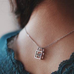 female-wearing-silver-necklace-with-beautiful-lock-pendant